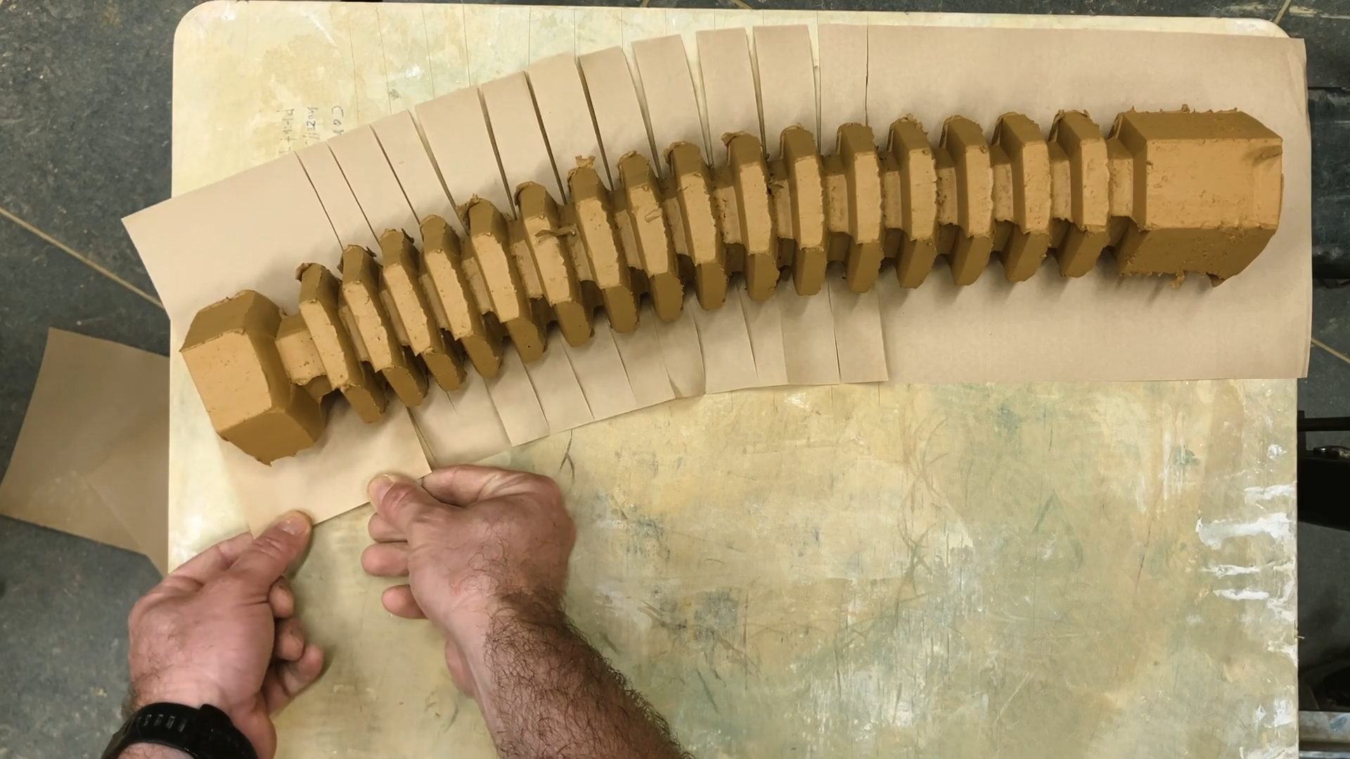 A color photo showing hands working on a project.
