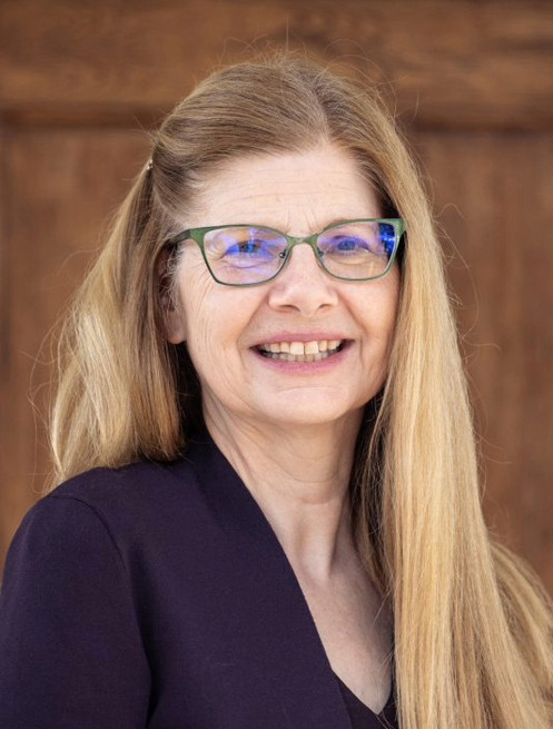 A color photo of a woman smiling for a portrait.