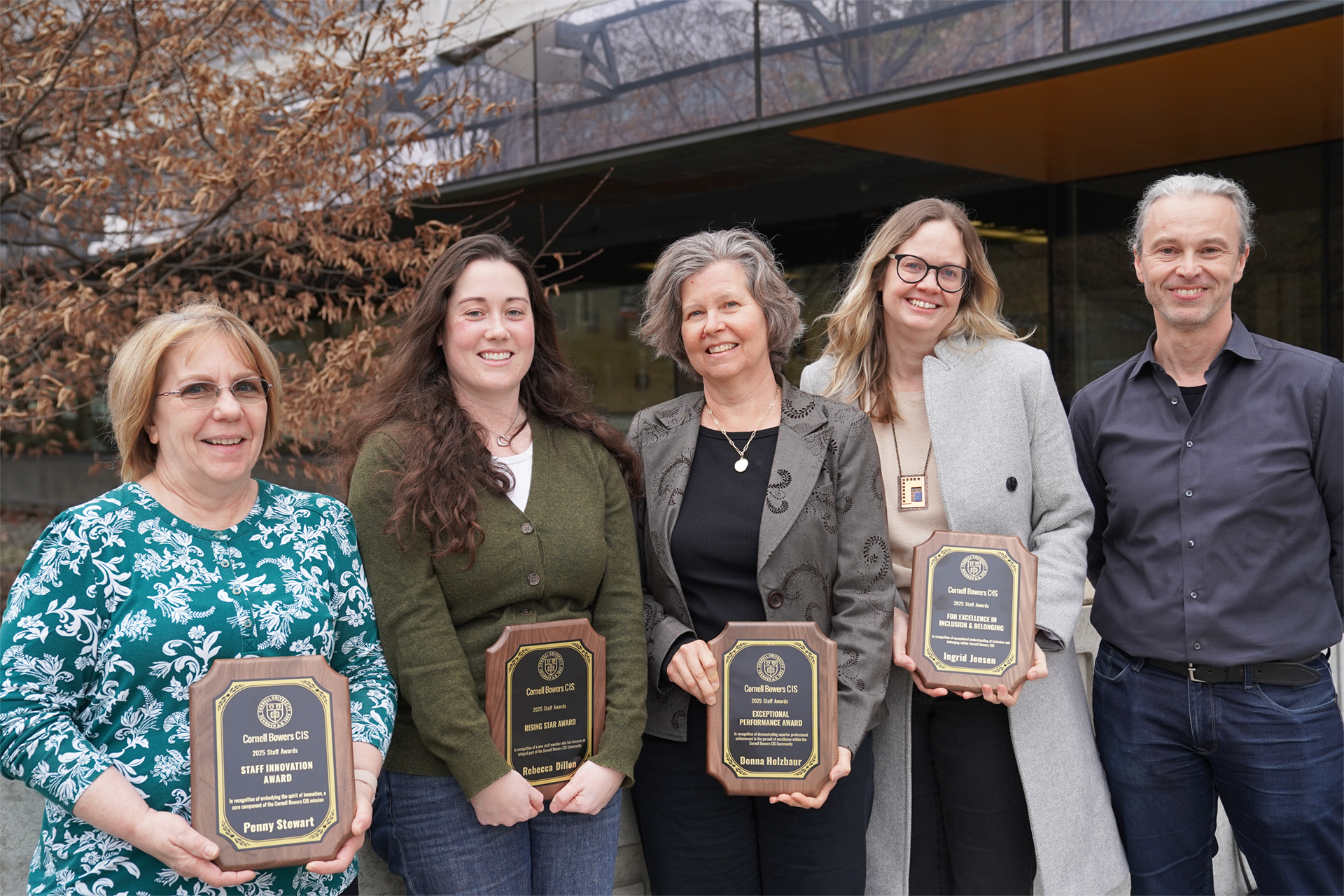 A color photo showing the staff award winners with the interim dean.