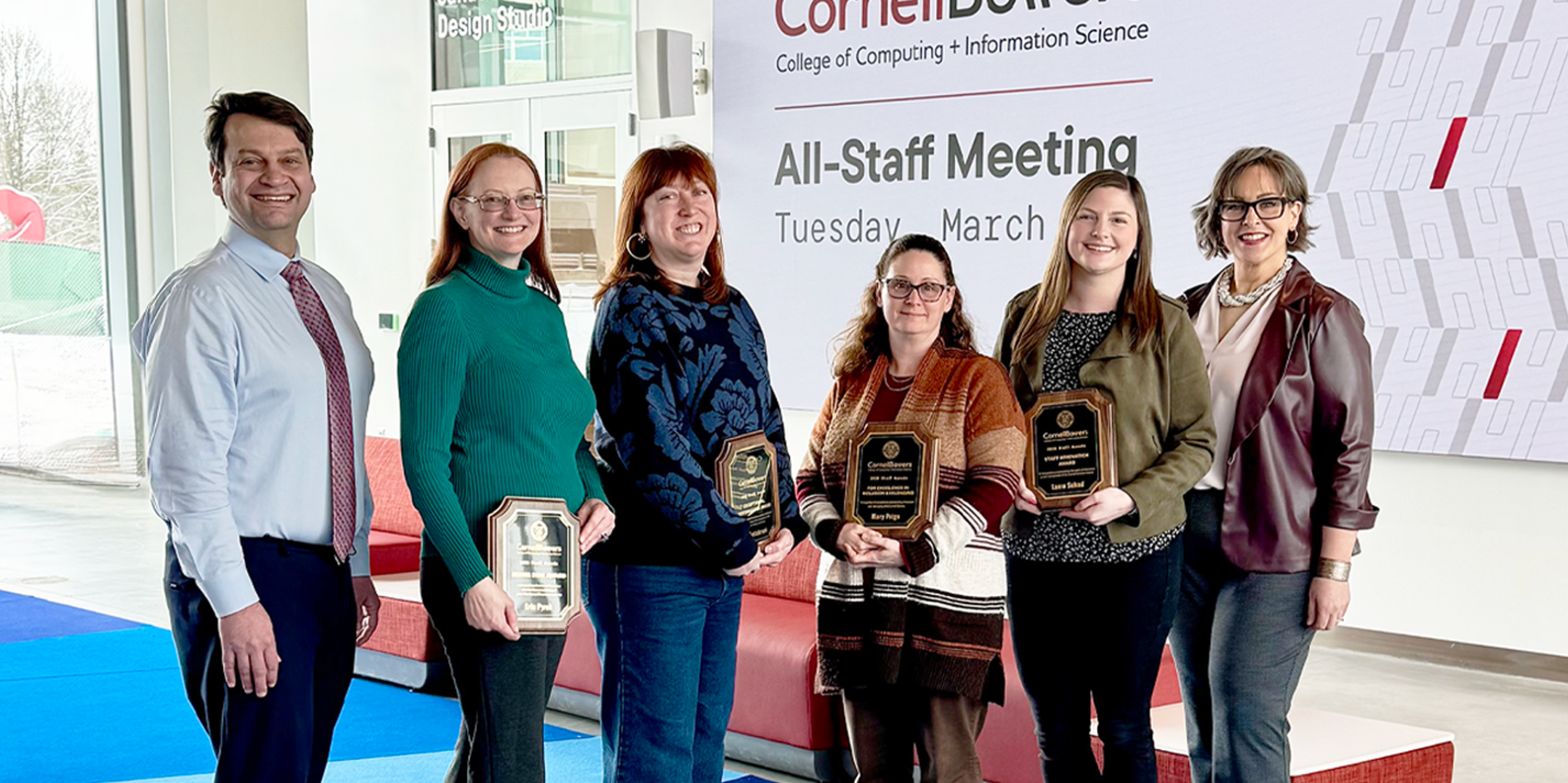 A color photo showing staff award winners and presenters.
