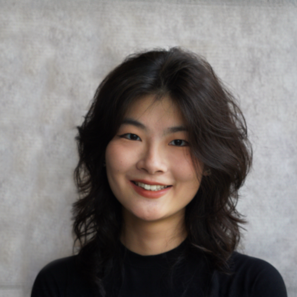A color photo of a woman smiling for a photo.