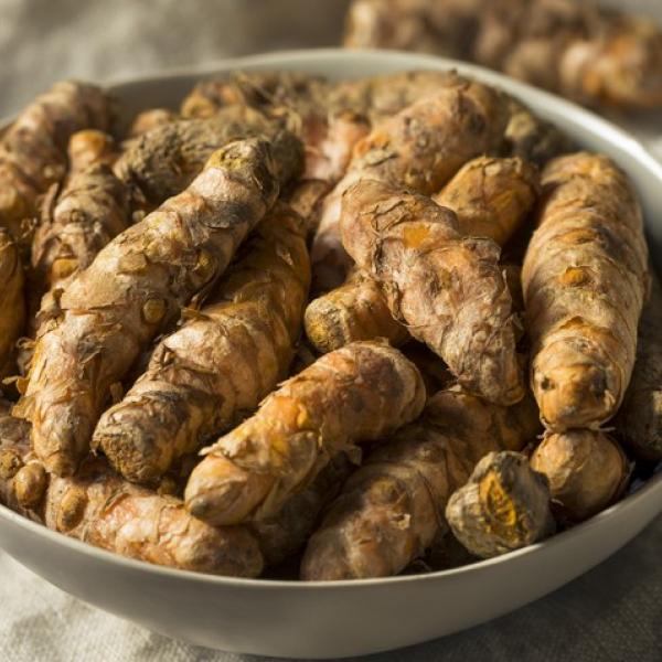 A white bowl full of tumeric
