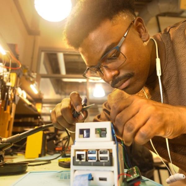Daniel Baldeo-Thorne ’25 works on a device for monitoring the health of greenhouse-grown plants, which he has developed as part of Rev: Ithaca’s Prototyping Hardware Accelerator.