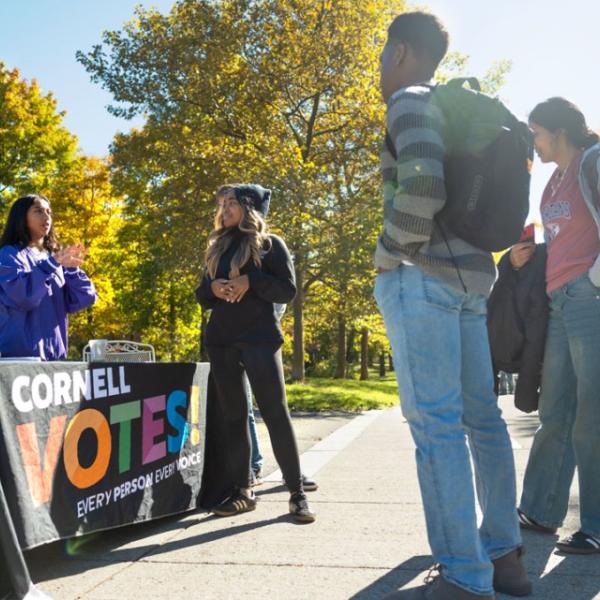 Students from the Cornell Policy Group, a nonpartisan student organization, help others register to vote on Ho Plaza.
