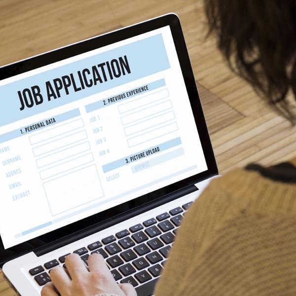Person views a laptop screen that displays "Job Application"