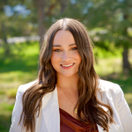 A color photo of Rebecca Fox standing outside