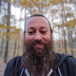 A color photo of Matt Thomas in the woods
