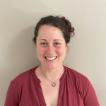 A color photo of Rebecca Dillon in front of an off-white background