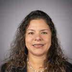 A color photo of Yl Guanchez in front of a grey background