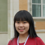 A color photo of a woman smiling for a photo.