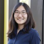 A photo of Jennifer J. Sun, a woman with long dark hair, glasses and a blue shirt
