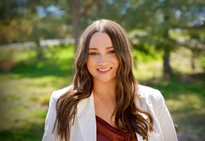 A color photo of Rebecca Fox standing outside