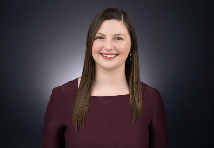 A color photo of Laura Schad in front of a dark background