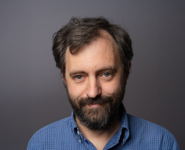 A color photo of man with beard and dark hair