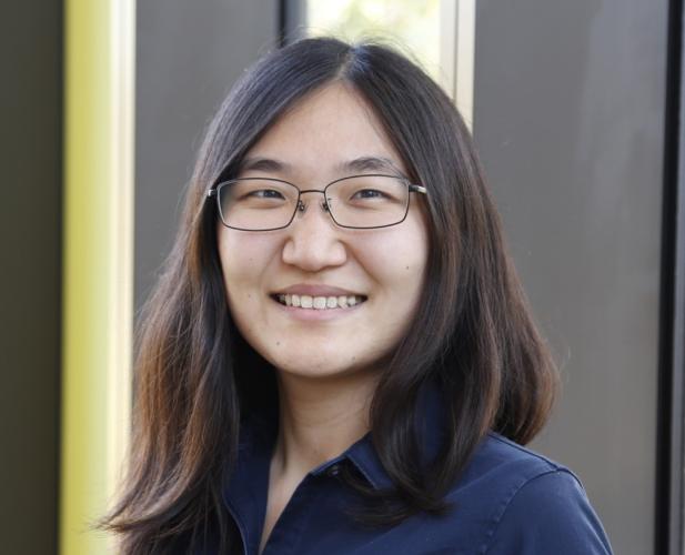 A photo of Jennifer J. Sun, a woman with long dark hair, glasses and a blue shirt