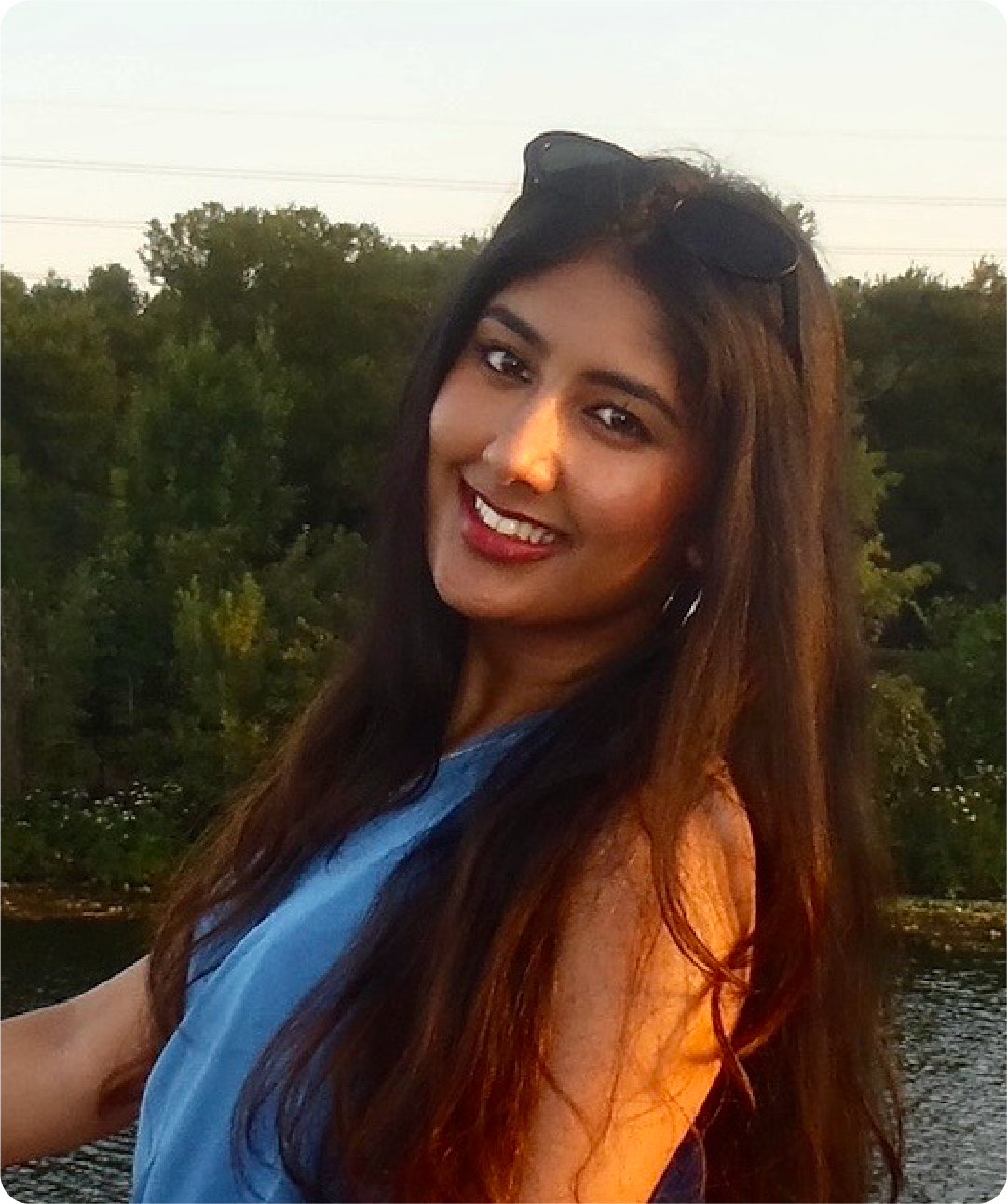 A color photo of a woman smiling for a photo.